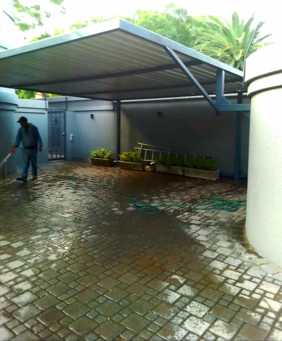 Canti lever carport installation by Pretoria Gates (Pty) Ltd Cantilever carport installation at Pretoria Gates Pty Ltd showing steel frame structure and covered parking area